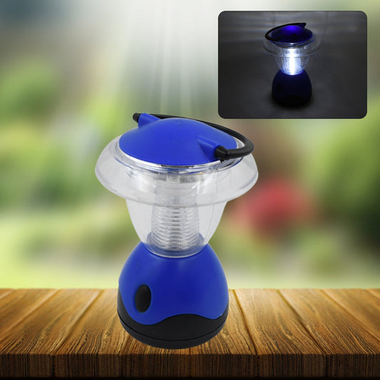 A blue and clear plastic mini lantern sits on a wooden table, with a small inset showing it glowing in the dark.