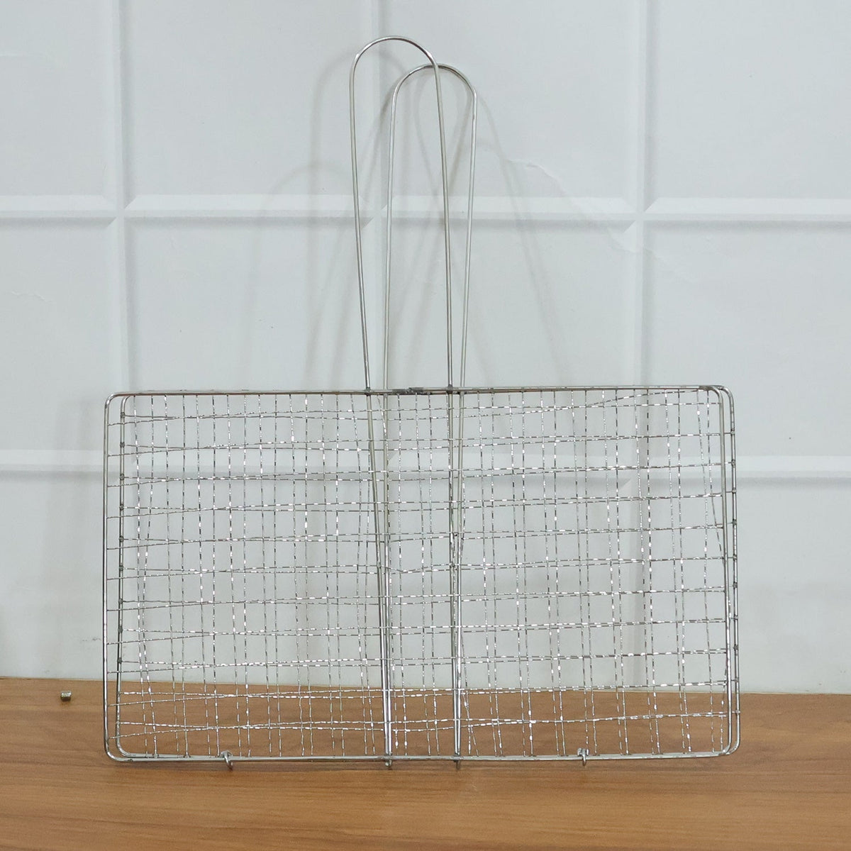 Heavy-duty stainless steel grill basket suitable for camping and picnics